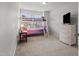 Charming bedroom featuring a bunk bed, adjacent to a wicker dresser and side table, offering a functional design at 136 Thornhill Dr, Burlington, NC 27215