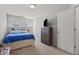 Comfortable bedroom with natural light from windows, TV and closet offering a cozy and functional space at 136 Thornhill Dr, Burlington, NC 27215