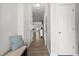 Hallway features neutral walls, and a bench with a pillow. Visible doorways to rooms at 136 Thornhill Dr, Burlington, NC 27215