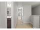 Neutral-toned hallway leads to a full bathroom and bedroom providing seamless connectivity and a well-lit path at 136 Thornhill Dr, Burlington, NC 27215