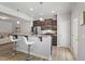 Well-lit kitchen features stainless steel appliances, granite countertops, and a convenient breakfast bar with stylish seating at 136 Thornhill Dr, Burlington, NC 27215