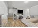 Open-concept living space with a fireplace, mounted TV, and comfortable seating at 136 Thornhill Dr, Burlington, NC 27215