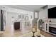 Open-concept living room with wood floors, dining area, fireplace, and lots of natural light is perfect for gathering at 136 Thornhill Dr, Burlington, NC 27215