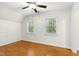 Bright bedroom featuring wood floors, a ceiling fan, and two windows providing natural light at 139 Trillium Pl, Chapel Hill, NC 27517