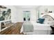 Bright bedroom features a comfortable bed and doors leading to an outdoor space at 139 Trillium Pl, Chapel Hill, NC 27517