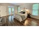 Comfortable bedroom features a decorative headboard and French doors leading to an outdoor space at 139 Trillium Pl, Chapel Hill, NC 27517