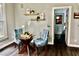 Bright eating area with decorative shelving and cozy seating for two at 139 Trillium Pl, Chapel Hill, NC 27517