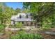 Charming home with a cozy front porch surrounded by lush greenery and trees, offering a peaceful retreat at 139 Trillium Pl, Chapel Hill, NC 27517