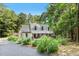 Charming home featuring a covered front porch and lush landscaping surrounded by mature trees in wooded setting at 139 Trillium Pl, Chapel Hill, NC 27517