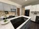 The kitchen features an island cooktop, marble countertops, and stainless appliances at 139 Trillium Pl, Chapel Hill, NC 27517