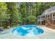 Inviting backyard pool surrounded by lush greenery and mature trees, perfect for relaxation at 139 Trillium Pl, Chapel Hill, NC 27517