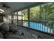 Relaxing screened porch offering wooded views and a refreshing glimpse of a swimming pool at 139 Trillium Pl, Chapel Hill, NC 27517