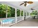 Spacious screened porch featuring an outdoor ceiling fan and wooded view at 139 Trillium Pl, Chapel Hill, NC 27517