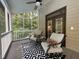 Relaxing screened porch featuring outdoor ceiling fan, seating, and wooded views at 139 Trillium Pl, Chapel Hill, NC 27517