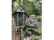 A handcrafted bee house and purple hydrangeas adorn the lovely garden at 139 Trillium Pl, Chapel Hill, NC 27517