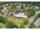 Aerial view of the community pool, surrounded by lush trees and residential homes at 1406 Pebble Creek Xing, Durham, NC 27713