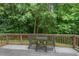View of the back deck featuring a small table and chairs, perfect for enjoying the outdoors at 1406 Pebble Creek Xing, Durham, NC 27713