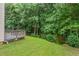View of the back yard and deck, which features a table and chairs perfect for relaxing outdoors at 1406 Pebble Creek Xing, Durham, NC 27713