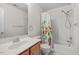 Bathroom with a vanity, a shower with patterned curtain and tile, and fixtures at 1406 Pebble Creek Xing, Durham, NC 27713