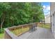 Wooden deck with table and chairs, perfect for outdoor relaxation with a view of the backyard at 1406 Pebble Creek Xing, Durham, NC 27713
