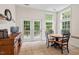 Bright dining area with French doors to the deck, light tile floors, and a wood table at 1406 Pebble Creek Xing, Durham, NC 27713