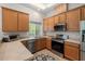 Functional kitchen featuring stainless steel appliances, ample counter space, and wood cabinetry at 1406 Pebble Creek Xing, Durham, NC 27713