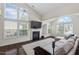 Bright living room featuring large windows, a fireplace, and a comfortable sectional sofa at 1406 Pebble Creek Xing, Durham, NC 27713