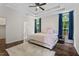 Spacious main bedroom featuring tray ceilings, a ceiling fan and natural light from two windows at 1406 Pebble Creek Xing, Durham, NC 27713