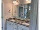 Bathroom featuring double sinks, granite countertop and a large mirror above the vanity at 146 Verona Villa Dr, Burlington, NC 27215