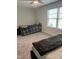 Simple bedroom with carpet, light-colored walls, two twin beds, and a large window at 146 Verona Villa Dr, Burlington, NC 27215