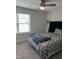 Bedroom features carpet, light-colored walls, a stylish bed, and a well-lit window at 146 Verona Villa Dr, Burlington, NC 27215