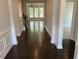 Hallway showcasing gleaming hardwood floors and an open view to a bright living space at 146 Verona Villa Dr, Burlington, NC 27215