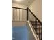 Carpeted stairwell featuring white trim and iron balusters at 146 Verona Villa Dr, Burlington, NC 27215