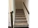 Carpeted stairwell featuring a dark-stained banister and white trim at 146 Verona Villa Dr, Burlington, NC 27215
