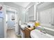 Bathroom featuring a double sink vanity, cabinetry, and natural light at 1634 Claiborne Ct, Raleigh, NC 27606