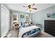 Inviting bedroom with a ceiling fan, windows, and light blue walls at 1634 Claiborne Ct, Raleigh, NC 27606