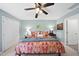 Bright bedroom featuring a ceiling fan, double closet, and natural light at 1634 Claiborne Ct, Raleigh, NC 27606