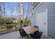 Outdoor deck featuring a dining table with views of the wooded yard at 1634 Claiborne Ct, Raleigh, NC 27606
