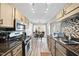 Stylish kitchen featuring stainless steel appliances, wood cabinets, and ample counter space for cooking at 1634 Claiborne Ct, Raleigh, NC 27606
