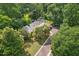 Aerial view of house surrounded by mature trees, green lawn and winding driveway at 1846 Hammond St, Rocky Mount, NC 27803