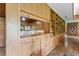 Charming bar area featuring wood cabinets, shelving, and a mirrored backsplash for entertaining at 1846 Hammond St, Rocky Mount, NC 27803