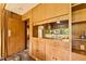Charming bar area with wood paneling, built-in cabinets, and mirrored backsplash at 1846 Hammond St, Rocky Mount, NC 27803