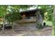 Stone house with balcony and large windows, surrounded by trees and greenery for added privacy at 1846 Hammond St, Rocky Mount, NC 27803