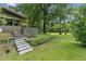 Inviting home featuring stone steps, lush greenery, and well-manicured lawn for a tranquil setting at 1846 Hammond St, Rocky Mount, NC 27803