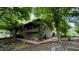 Beautiful stone house with balcony, complemented by mature trees and landscaped yard at 1846 Hammond St, Rocky Mount, NC 27803