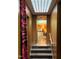 Hallway with stone steps, wood paneling, and a view into another room with warm lighting and decor at 1846 Hammond St, Rocky Mount, NC 27803