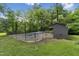 Fenced in pool with pool house sitting within mature green trees at 1846 Hammond St, Rocky Mount, NC 27803