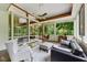 Bright sunroom with large windows, tile floors, stylish furnishings, and views of the surrounding greenery at 1846 Hammond St, Rocky Mount, NC 27803