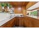Classic wet bar with wood cabinets, open shelving, and a sink for convenient entertaining at 1846 Hammond St, Rocky Mount, NC 27803