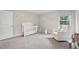 Bright and airy Bedroom with soft gray walls, plush carpeting, and a comfortable glider chair near the crib at 195 Solomon Dr, Cameron, NC 28326